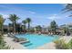 Resort-style pool with comfortable lounge chairs, palm trees, and community amenities at 11257 Rainbow Peak Ave # 201, Las Vegas, NV 89135