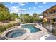 Beautiful backyard featuring a sparkling pool, spa, playset and privacy landscaping at 12254 Cape Cortez Ct, Las Vegas, NV 89138