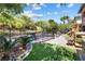A landscaped backyard with a pool, playset, and grassy area perfect for outdoor enjoyment at 12254 Cape Cortez Ct, Las Vegas, NV 89138