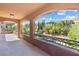 A covered balcony with a view of the landscaped backyard and greenery at 12254 Cape Cortez Ct, Las Vegas, NV 89138