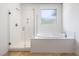 Modern bathroom with glass-enclosed shower, soaking tub, and tiled flooring at 12254 Cape Cortez Ct, Las Vegas, NV 89138