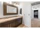 Well-lit bathroom with double sink vanity, granite countertops, and decorative mirror at 12254 Cape Cortez Ct, Las Vegas, NV 89138