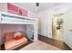 Pink bedroom featuring a loft bed with built-in desk and a comfortable seating area at 12254 Cape Cortez Ct, Las Vegas, NV 89138