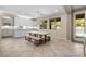 Bright dining area features white cabinetry, granite countertops, and a modern chandelier at 12254 Cape Cortez Ct, Las Vegas, NV 89138
