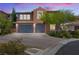 Charming two-story home with a paver driveway, attached garage, and tasteful desert landscaping at 12254 Cape Cortez Ct, Las Vegas, NV 89138