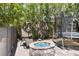 An outdoor fire pit area with seating and a trampoline at 12254 Cape Cortez Ct, Las Vegas, NV 89138
