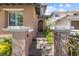 Inviting walkway to the arched front door with decorative pillars and iron railing at 12254 Cape Cortez Ct, Las Vegas, NV 89138