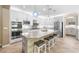 Modern kitchen with stainless steel appliances, granite countertops, large island, and pendant lighting at 12254 Cape Cortez Ct, Las Vegas, NV 89138