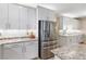 Modern kitchen features stainless steel refrigerator, white cabinets, and granite countertops at 12254 Cape Cortez Ct, Las Vegas, NV 89138