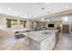 Open-concept kitchen and dining area with granite countertops and a large kitchen island at 12254 Cape Cortez Ct, Las Vegas, NV 89138