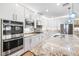 Bright kitchen with stainless steel appliances, modern white cabinets, and granite countertops at 12254 Cape Cortez Ct, Las Vegas, NV 89138