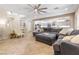 Open-concept living space features tile floors, a large sectional sofa, and seamless flow to the kitchen at 12254 Cape Cortez Ct, Las Vegas, NV 89138