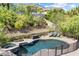 A refreshing backyard pool with an attached spa area and lounge chairs at 12254 Cape Cortez Ct, Las Vegas, NV 89138