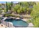 A backyard pool with a spa and lush landscaping that provides a private oasis at 12254 Cape Cortez Ct, Las Vegas, NV 89138