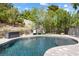 Secluded swimming pool area features lounge chairs and mature landscaping for privacy at 12254 Cape Cortez Ct, Las Vegas, NV 89138