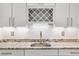 Wet bar features granite countertops, wine rack, modern fixtures, and outdoor access at 12254 Cape Cortez Ct, Las Vegas, NV 89138