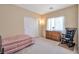 Cozy bedroom with a rocking chair, window, and closet at 129 Sapodilla Ln, Las Vegas, NV 89144