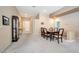 Elegant dining area with a classic wooden table, carpet flooring, and neutral paint color throughout at 129 Sapodilla Ln, Las Vegas, NV 89144