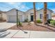 Attractive single-story home with attached garage, mature palm trees, and desert landscaping at 129 Sapodilla Ln, Las Vegas, NV 89144