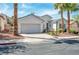 Inviting single-Gathering home featuring a two-car garage and desert-friendly landscaping at 129 Sapodilla Ln, Las Vegas, NV 89144