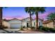 Charming single story home with palm trees and a well-manicured front yard at 129 Sapodilla Ln, Las Vegas, NV 89144