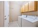 Functional laundry room features a washer, dryer, and built-in cabinets at 129 Sapodilla Ln, Las Vegas, NV 89144
