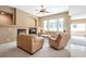 Open concept living room featuring a fireplace, large windows, neutral tones, and comfortable seating at 129 Sapodilla Ln, Las Vegas, NV 89144
