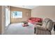 Comfortable living room with natural light and neutral carpeting at 129 Sapodilla Ln, Las Vegas, NV 89144