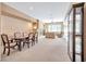 Spacious living room and dining room combo with carpet, fireplace, and large windows for natural light at 129 Sapodilla Ln, Las Vegas, NV 89144