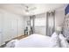 Bedroom with a tufted headboard, fan, wood-look flooring, and gray curtains and bedding at 1508 Dorothy Ave # 4, Las Vegas, NV 89119