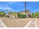 A clear view of a two-story home featuring tidy landscaping and a distinctive desert tree at 1508 Dorothy Ave # 4, Las Vegas, NV 89119