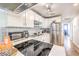 A bright kitchen with white cabinets, stainless steel appliances, quartz countertops and breakfast bar seating at 1508 Dorothy Ave # 4, Las Vegas, NV 89119