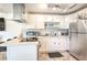 Updated kitchen features white cabinets, stainless steel appliances, quartz countertops and patterned tile flooring at 1508 Dorothy Ave # 4, Las Vegas, NV 89119