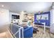 Open living space featuring modern kitchen, dining area, and stylish blue sofa at 1508 Dorothy Ave # 4, Las Vegas, NV 89119