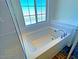 Bright bathroom featuring a soaking tub with tile surround at 20 Barbara Ln # 47, Las Vegas, NV 89183