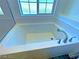 Oversized bathtub with sleek fixtures and subway tile surround for a relaxing bath at 20 Barbara Ln # 47, Las Vegas, NV 89183