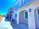 A row of modern townhomes feature covered entrances, neutral colors, and meticulous xeriscaping, offering stylish curb appeal at 20 Barbara Ln # 47, Las Vegas, NV 89183