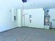Spacious garage with concrete flooring, white walls, and an installed water heater system at 20 Barbara Ln # 47, Las Vegas, NV 89183