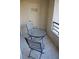Balcony with a round table and two chairs overlooking the neighborhood at 220 E Flamingo Rd # 104, Las Vegas, NV 89169