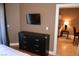 Cozy bedroom featuring a dresser with a TV and an open doorway at 220 E Flamingo Rd # 104, Las Vegas, NV 89169