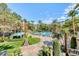 Resort-style pool area surrounded by lush landscaping, palm trees, and comfortable lounge chairs at 220 E Flamingo Rd # 104, Las Vegas, NV 89169