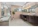 Bathroom with dual sinks, a soaking tub, and modern lighting fixtures at 2337 Prometheus Ct, Henderson, NV 89074