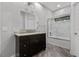 Well-lit bathroom featuring dark wood vanity and marble shower with glass doors at 2337 Prometheus Ct, Henderson, NV 89074
