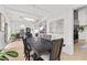 Elegant dining room with contemporary lighting, a long wooden table, and modern decor at 2337 Prometheus Ct, Henderson, NV 89074
