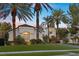 Charming single-story home with palm trees, lush landscaping, and a well-manicured lawn at 2337 Prometheus Ct, Henderson, NV 89074