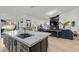Open-concept kitchen with marble countertops, dark cabinetry, and stainless steel appliances at 2337 Prometheus Ct, Henderson, NV 89074