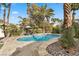 Secluded pool oasis with tropical landscaping, flagstone decking, and lounge chairs at 2337 Prometheus Ct, Henderson, NV 89074