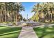 Grand water feature surrounded by lush landscaping and mature palm trees at 2337 Prometheus Ct, Henderson, NV 89074