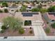 An aerial view of the home shows a tile roof with solar panels, a xeriscaped yard and a two car driveway at 2512 Desert Glen Dr, Las Vegas, NV 89134