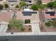 Home featuring solar panels, desert landscaping and a long driveway; aerial view shows roof and surroundings at 2512 Desert Glen Dr, Las Vegas, NV 89134
